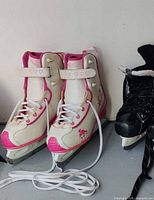 White and pink girls figure skates front and side view showing size and laces