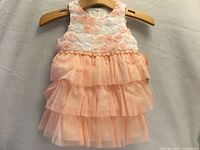 Front view of Mia & Mimi pale peach dress with layered skirt.