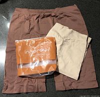 Brown and beige slip shorts with Innersy packaging visible