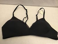 Front view of black Aerie bra showing cups, lace trim, straps, tag attached