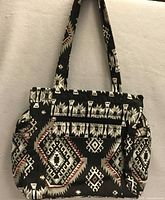 Front view of handbag showing Aztec print, three front pockets, gathered side pockets and straps