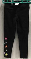 Full view of leggings showing black color and star design