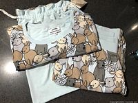 Full view of pajama top, pants and pouch