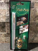 Front view of sealed Fish Pen package showing pen-style rod and gold reel