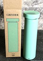 Grinder standing beside original box