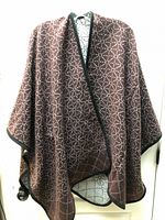 Front view of poncho scarf showing burgundy side and geometric pattern