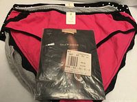 Three briefs stacked with packaged Talbots silky sheer pantyhose on top