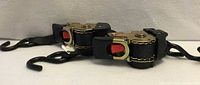 Two DC Cargo Mall retractable ratchet straps side by side showing hooks and ratchet mechanisms