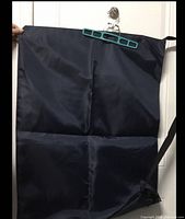 Full view of navy laundry bag hanging, showing size and color