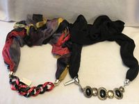 Both infinity scarf necklaces laid out side by side