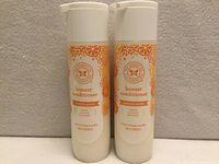 Front view of two sealed conditioner bottles showing labels and scent information