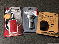 Three packaged LED lighting items on countertop