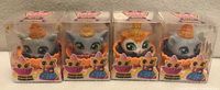 Front view of four sealed Kitty Cake Pets in original clear packaging