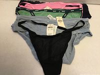 Five underwear laid out, tags visible