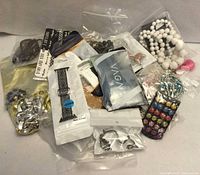 Pile of assorted sealed jewelry items and accessories