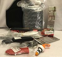 Overview of all sealed kitchen items including lunch tote, grill mat, filter box, utensils