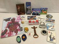 Group shot of approx. 21 assorted Canadian souvenir magnets laid out on flat surface