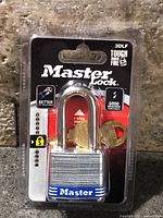 Front of sealed retail package showing Master Lock 3DLF padlock and keys