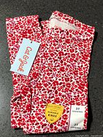 Folded leggings showing floral pattern, brand tag and Tough Cotton badge