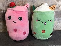 Front view of both plush toys showing overall design and condition