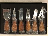 Full view of six-piece cheese knife set in box, all knives wrapped