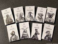 Front view of nine Zoologist sample cards showing titles and artwork