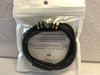 Front view of sealed package showing bracelet coiled, sentiment card visible