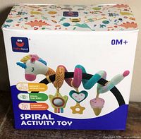 Front of retail box showing Hahaland Unicorn Spiral Activity Toy, unicorn design and hanging sensory pieces