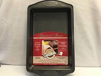 Front view of Wilton 9×13 pan with retail insert