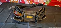 Overall view of DEWALT carpenter belt laid flat with tools visible in pouches