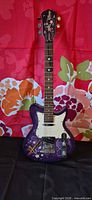 Front view of purple Hannah Montana electric guitar