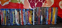 Full lot of approximately 40 movie cases lined in a row
