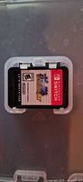 Front view of Pokkén Tournament DX cartridge inside clear case