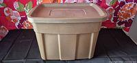 Front view of tan Rubbermaid storage tote with lid in place