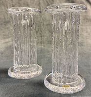 Two Kosta Boda Rurik crystal candle holders angled view
