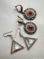 Both pairs of sterling silver earrings displayed together