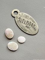 Front view of tag with three opals