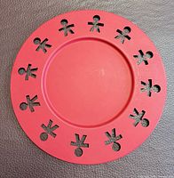Front view showing red tray with stick-figure cutouts