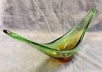 Side view showing green/amber sommerso layering and elongated shape