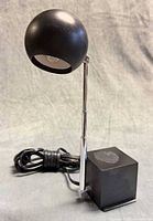 Lamp at lowest height showing spherical shade, chrome stem, cube base, cord