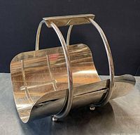 Front angled view showing curved cradle, side supports, ball feet