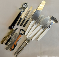 Wide shot of entire lot showing assorted corkscrews, bottle openers and pearlescent-handled utensils