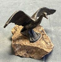 Front-left view of bronze Canadian goose on stone base