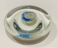 Top view showing clear glass disk and interior blue-yellow swirl