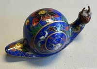 Left side view showing overall form and floral cloisonné detail