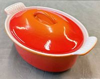 Dutch oven with lid in place showing orange-to-red gradient finish