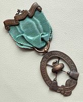 Full view of medal showing ribbon, suspension ring and pendant