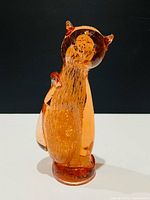 Front view of amber glass cat figurine