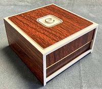 Closed Elgin box angled view showing wood-grain exterior and trim