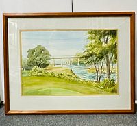 Full view of framed watercolor landscape painting in wood frame